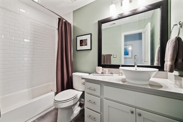 bathroom with visible vents, toilet, tile patterned floors, shower / bath combination with curtain, and vanity