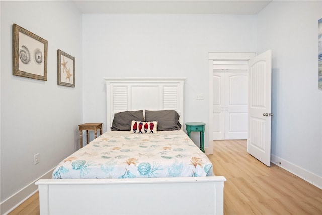 bedroom featuring light wood-style flooring and baseboards