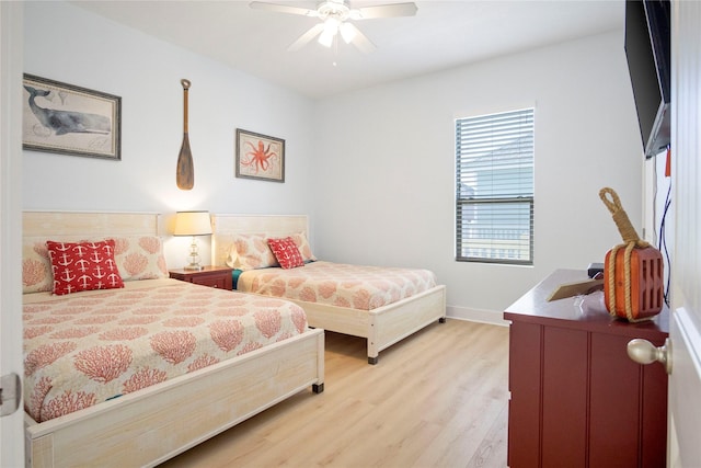 bedroom with baseboards, ceiling fan, and light wood finished floors