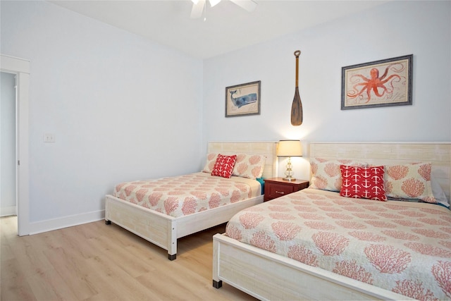 bedroom featuring ceiling fan, baseboards, and wood finished floors