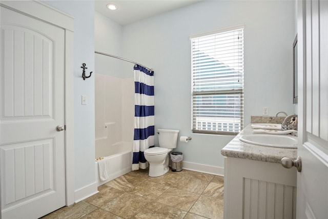 full bath featuring baseboards, double vanity, a sink, toilet, and shower / tub combo with curtain