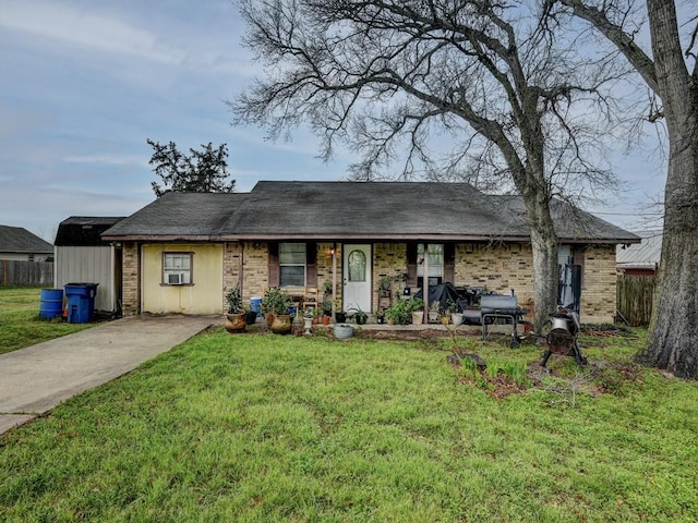 single story home featuring brick siding, covered porch, a front lawn, and fence