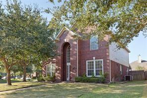 traditional-style home featuring a front lawn and fence