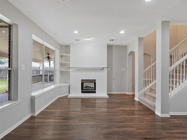 23134 Beech Canyon Dr, Katy, TX 77494 - unfurnished living room featuring wood finished floors, stairs, recessed lighting, and a fireplace