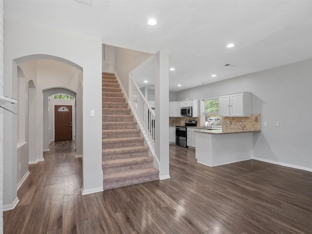23134 Beech Canyon Dr, Katy, TX 77494 - stairway with wood finished floors, arched walkways, baseboards, and recessed lighting