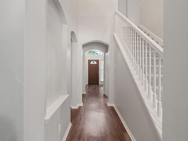 23134 Beech Canyon Dr, Katy, TX 77494 - corridor with arched walkways, dark wood-style floors, and baseboards