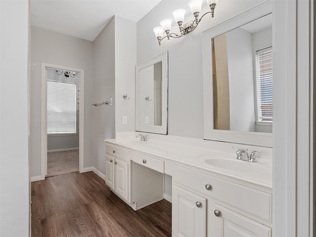 23134 Beech Canyon Dr, Katy, TX 77494 - bathroom featuring wood finished floors, double vanity, and baseboards
