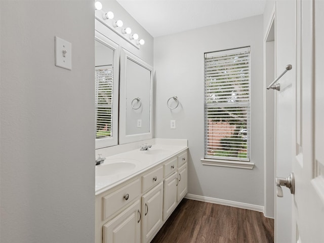 23134 Beech Canyon Dr, Katy, TX 77494 - bathroom featuring wood finished floors, double vanity, and baseboards