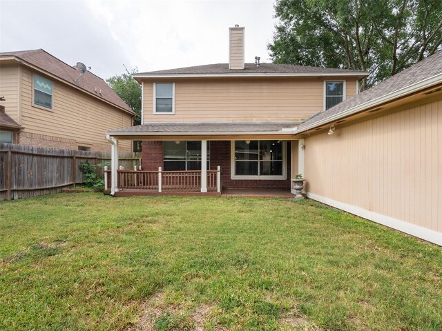 23134 Beech Canyon Dr, Katy, TX 77494 - back of property featuring a chimney, brick siding, and a patio area