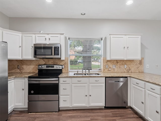 23134 Beech Canyon Dr, Katy, TX 77494 - kitchen with appliances with stainless steel finishes, a sink, white cabinets, dark wood-style floors, and recessed lighting
