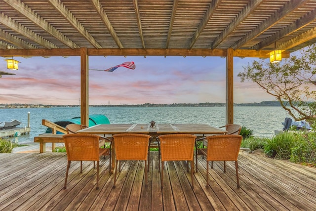 view of dock with a pergola and a water view