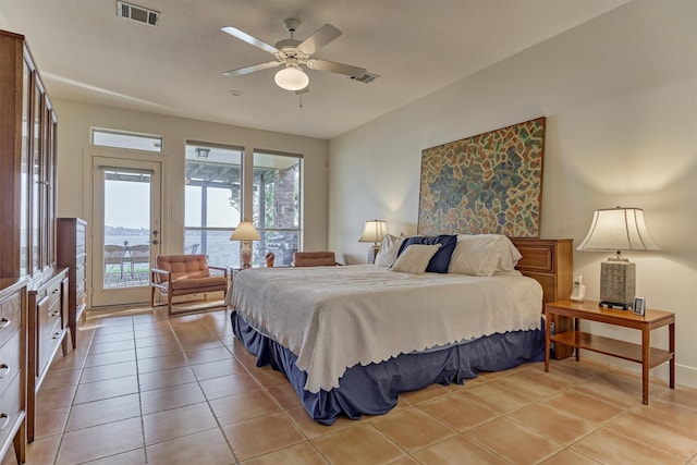 bedroom featuring access to exterior, light tile patterned floors, a ceiling fan, and visible vents