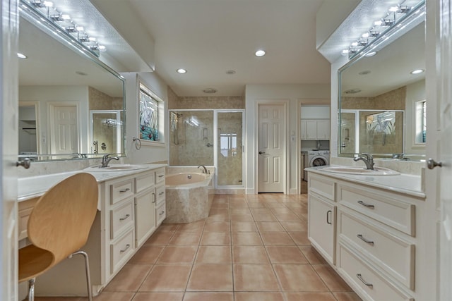 full bathroom with plenty of natural light, a sink, a shower stall, tile patterned floors, and washing machine and dryer