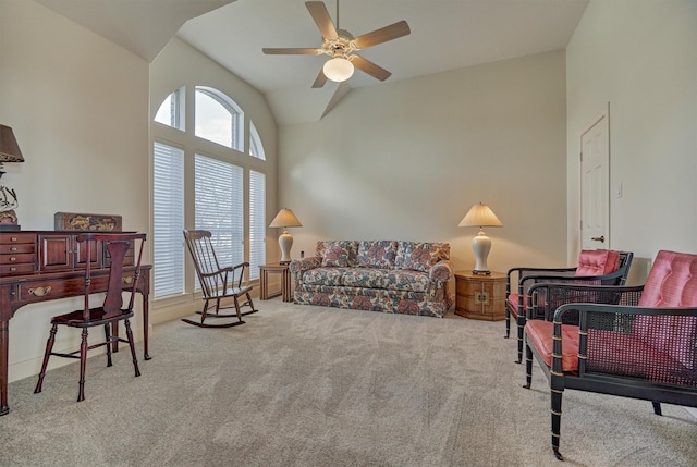 carpeted living area featuring ceiling fan and high vaulted ceiling