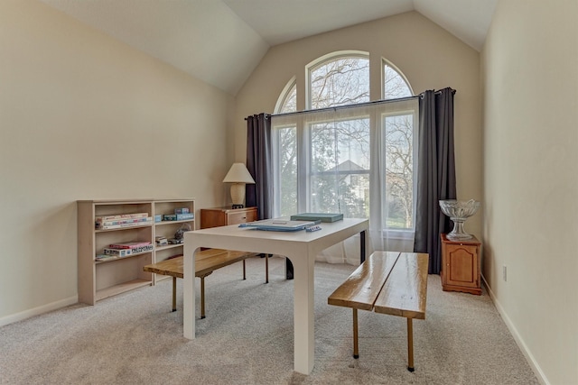 office area with carpet flooring, baseboards, and lofted ceiling