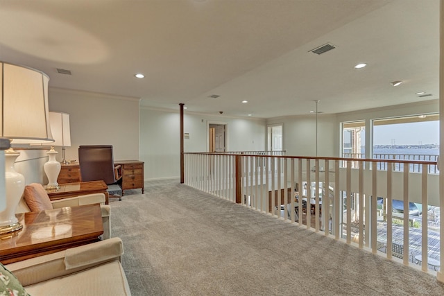 living area with recessed lighting, visible vents, ornamental molding, and carpet flooring