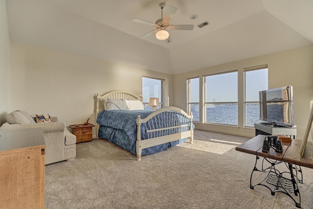 carpeted bedroom featuring visible vents, lofted ceiling, and ceiling fan