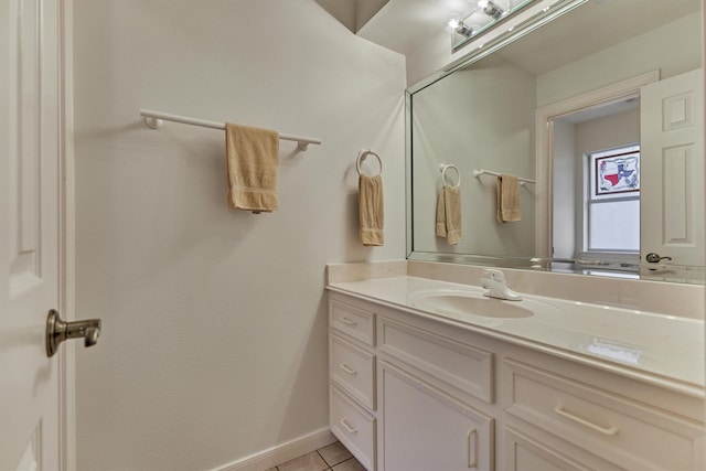 bathroom featuring vanity, tile patterned floors, and baseboards