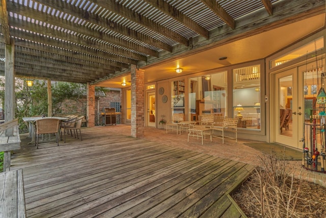 deck featuring outdoor dining space, french doors, and a pergola