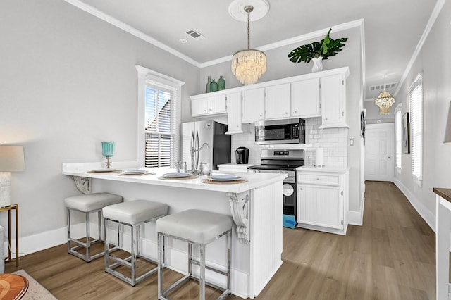 kitchen featuring tasteful backsplash, visible vents, white cabinetry, and stainless steel appliances