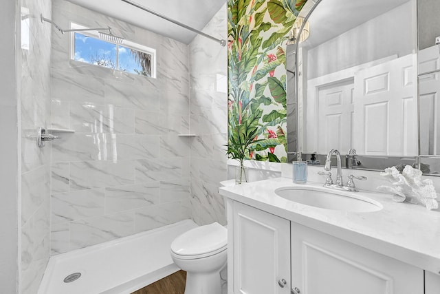 full bathroom featuring toilet, a stall shower, and vanity