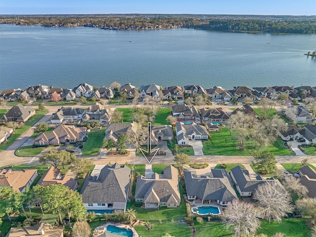 drone / aerial view featuring a residential view and a water view