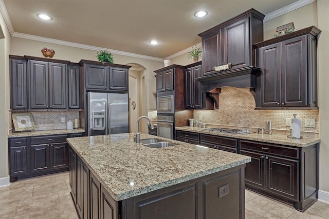 kitchen featuring a sink, stainless steel appliances, arched walkways, crown molding, and light stone countertops