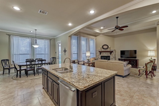 kitchen with visible vents, a sink, crown molding, dark brown cabinets, and dishwasher