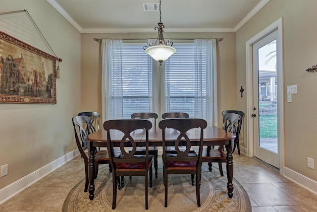 dining space featuring crown molding, light tile patterned flooring, baseboards, and visible vents