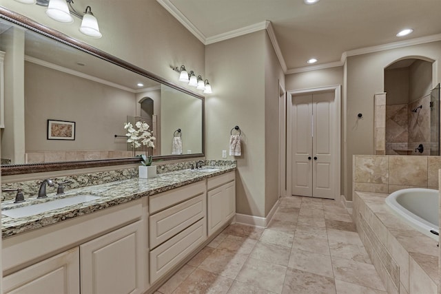 full bath with tiled shower, crown molding, baseboards, and a sink