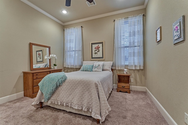 carpeted bedroom with visible vents, baseboards, and ornamental molding