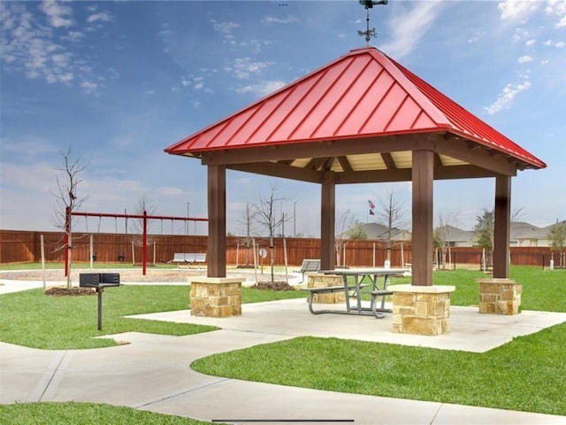 view of community featuring a gazebo, a yard, fence, and a patio area