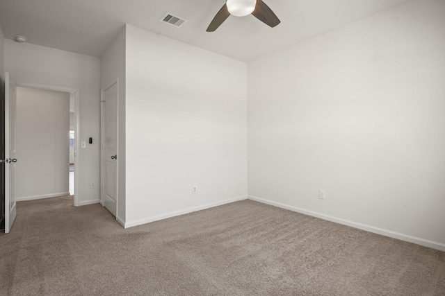 unfurnished room with baseboards, visible vents, and carpet floors