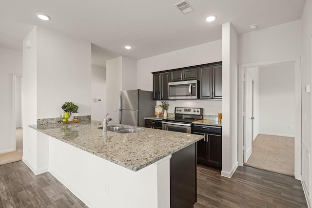 kitchen with visible vents, appliances with stainless steel finishes, dark wood-type flooring, and a sink