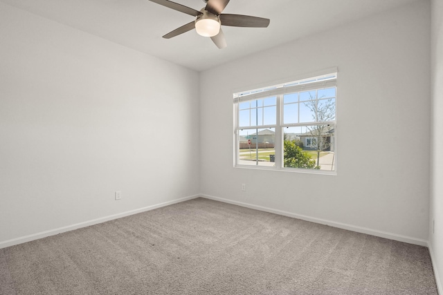 unfurnished room featuring a ceiling fan, baseboards, and carpet floors