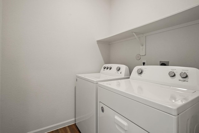 laundry area with laundry area, dark wood-style floors, separate washer and dryer, and baseboards