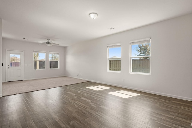 unfurnished living room featuring wood finished floors and baseboards