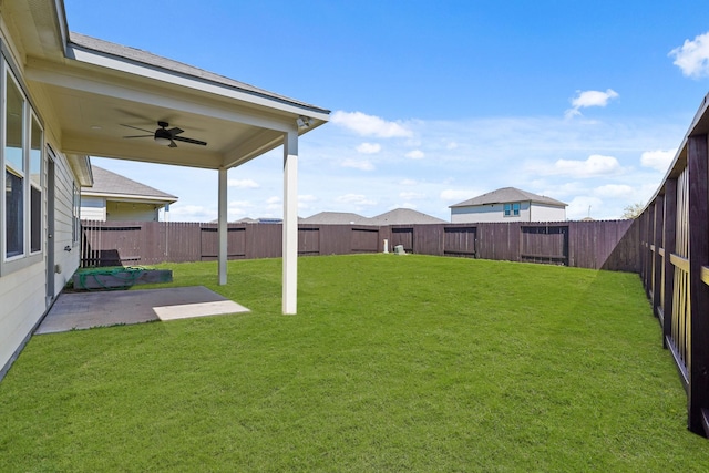 view of yard featuring a patio area, a fenced backyard, and ceiling fan