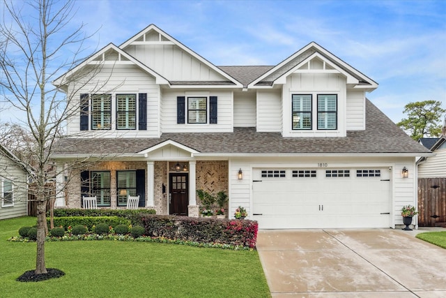 view of front of home featuring a porch, a front yard, concrete driveway, and board and batten siding