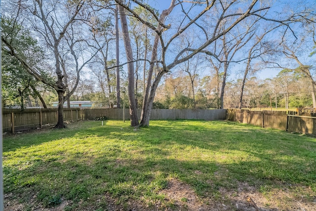 view of yard with a fenced backyard