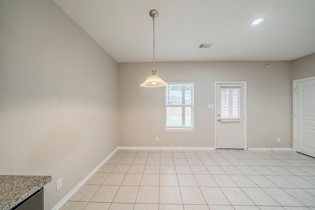 unfurnished dining area featuring light tile patterned floors, visible vents, and baseboards