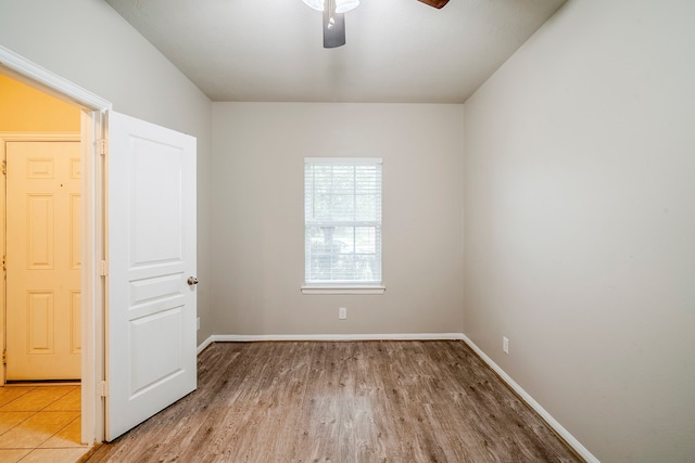 unfurnished room with a ceiling fan, baseboards, and light wood finished floors