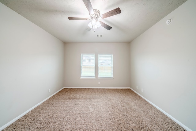 empty room featuring visible vents, baseboards, carpet floors, a textured ceiling, and a ceiling fan