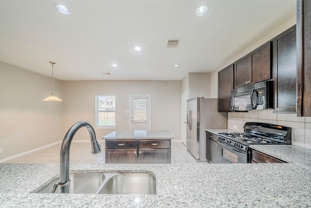 kitchen with visible vents, a sink, black appliances, dark brown cabinetry, and tasteful backsplash