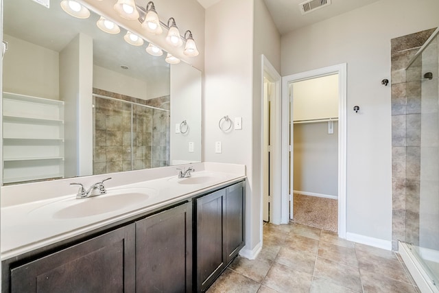 full bathroom featuring a shower stall, visible vents, and a sink