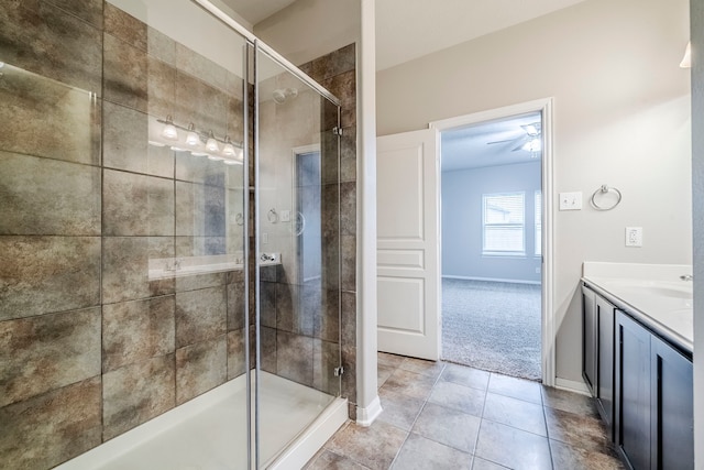 full bathroom with tile patterned flooring, a shower stall, vanity, and baseboards