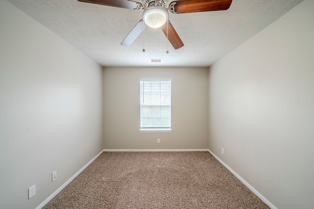 empty room featuring visible vents, baseboards, carpet, a textured ceiling, and a ceiling fan