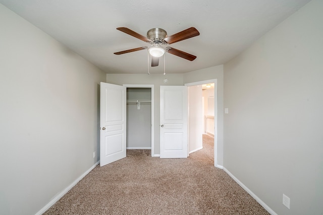 unfurnished bedroom featuring ceiling fan, baseboards, a closet, and light carpet