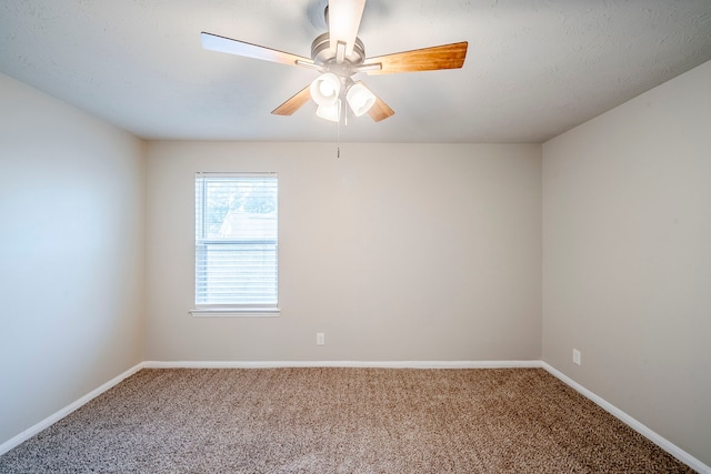 carpeted spare room with baseboards and ceiling fan