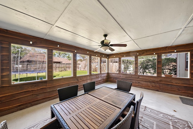 unfurnished sunroom with a ceiling fan